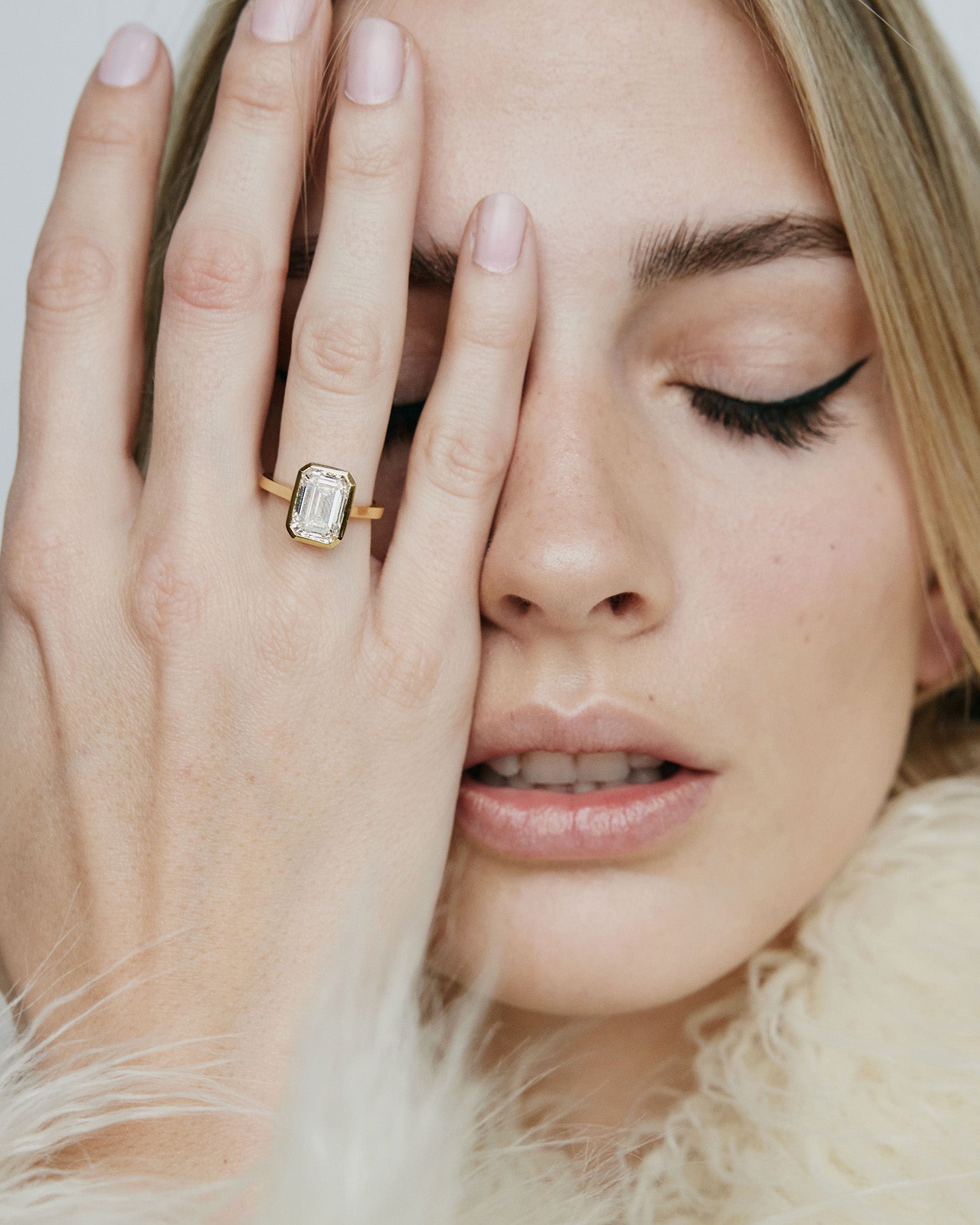 Model wearing rectangle  shaped diamond on gold band