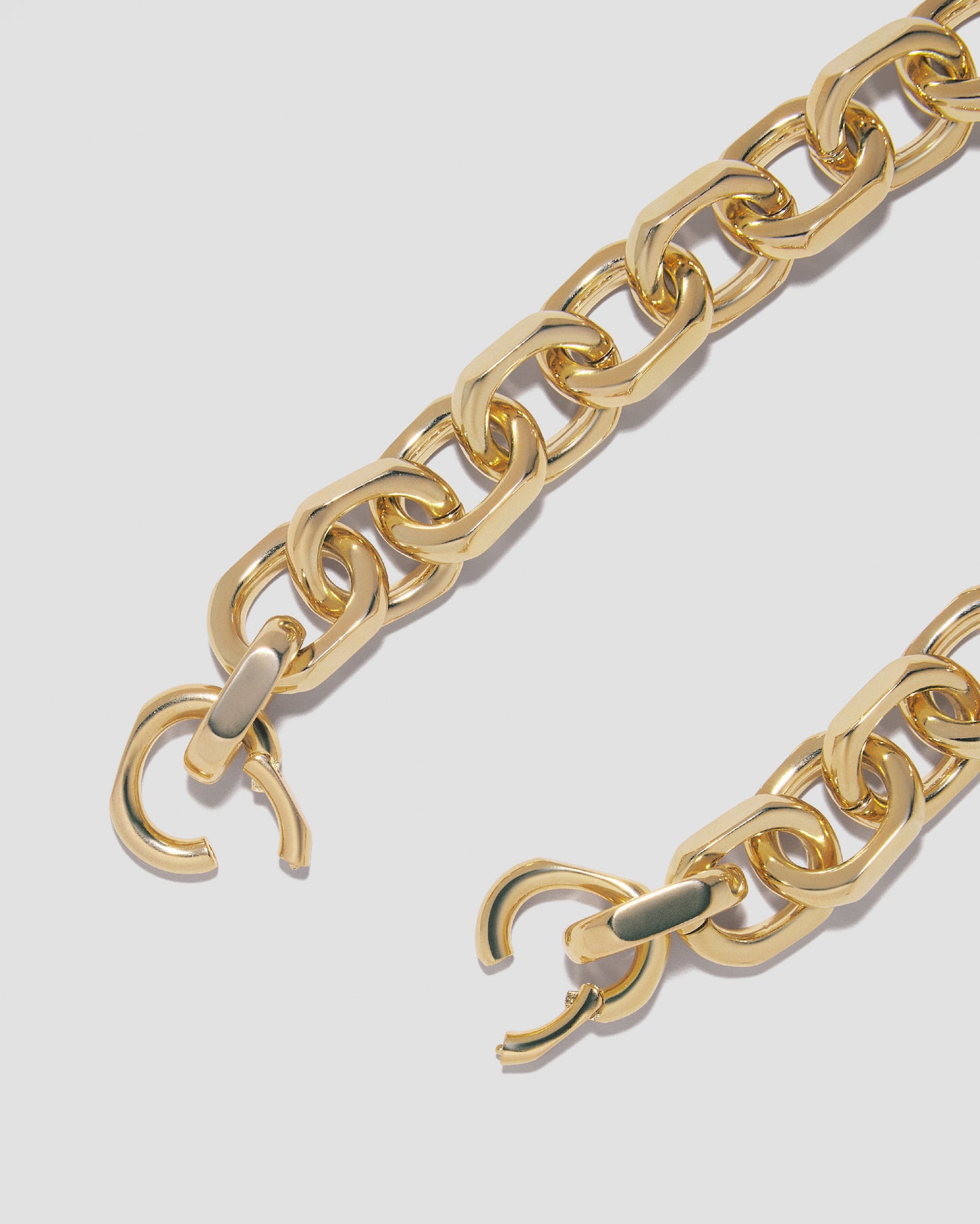 Close up of necklace clasp open on grey background.