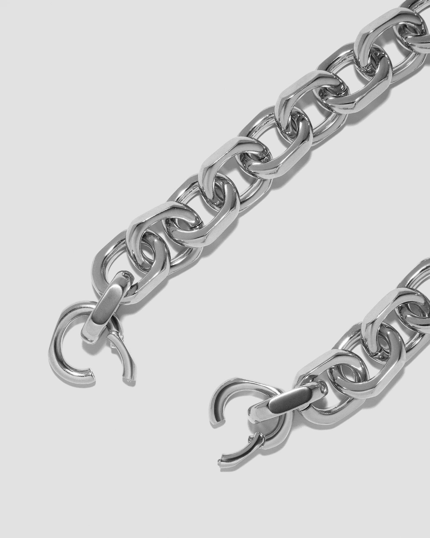 Close up of necklace clasp open on grey background.