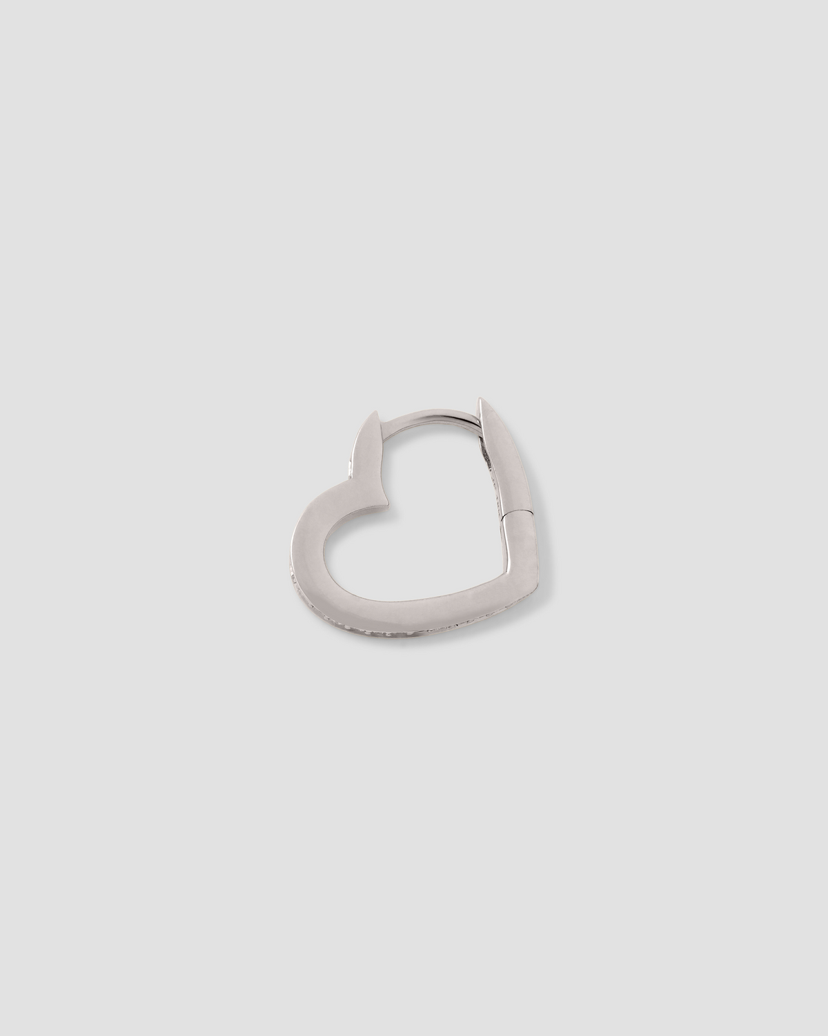18k Small Heart Huggie With Pavé White Diamonds gold earring - styled on model | diamond huggie earrings
