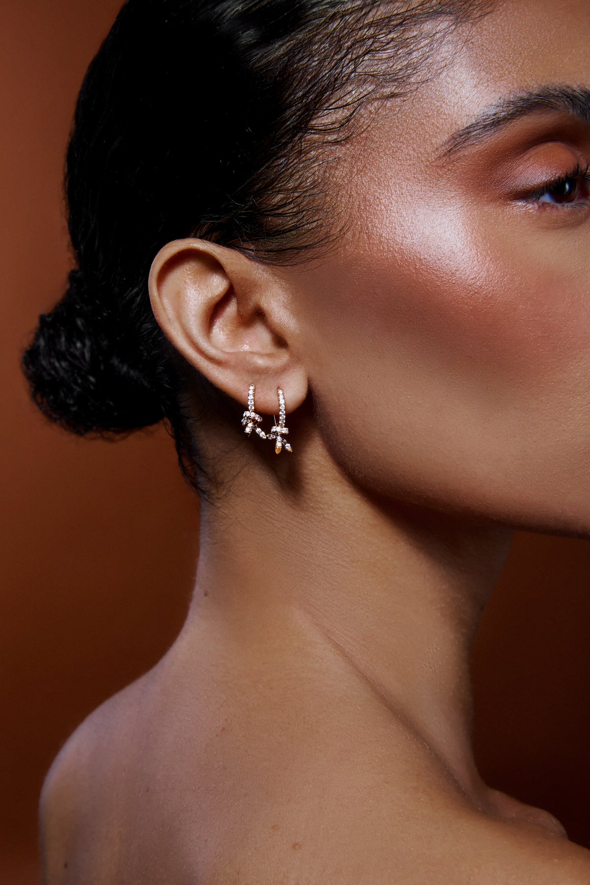 Knot Micro Huggie with Pavé White Diamonds gold earring - worn look | diamond huggie earrings