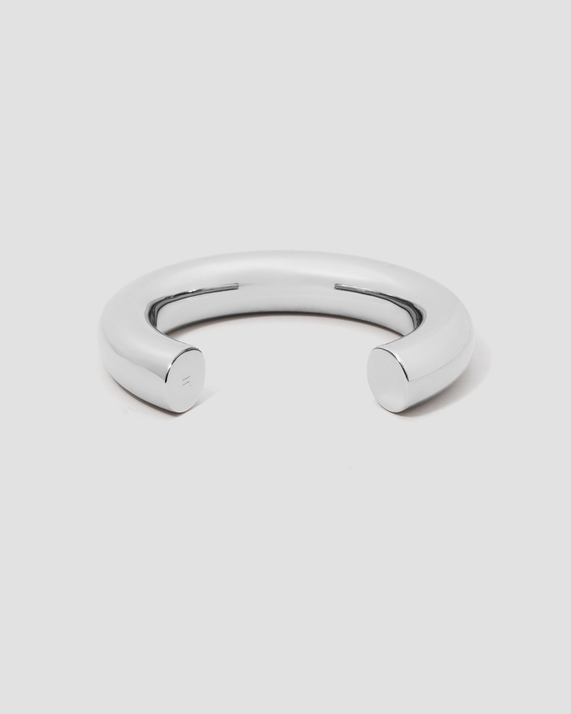 Silver bangle on a light gray background