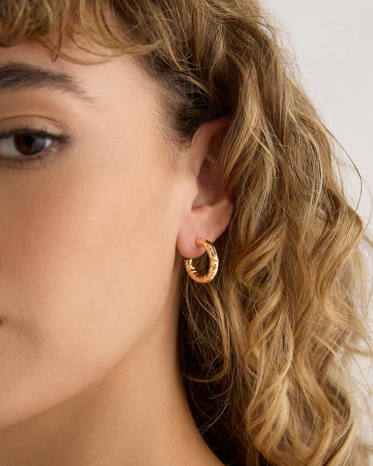 Hailey Micro Huggies earring - front view | gold huggie earrings