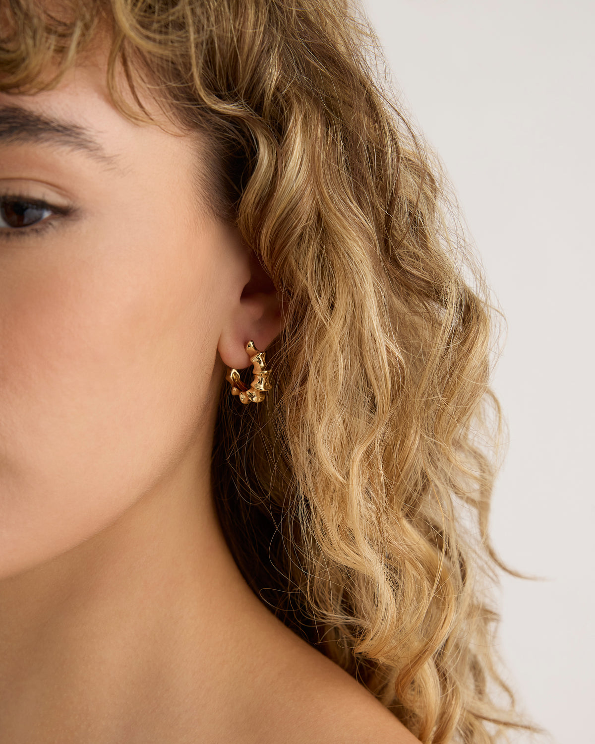 Murphy Micro Huggies earring - close-up detail | gold hoop earrings for women