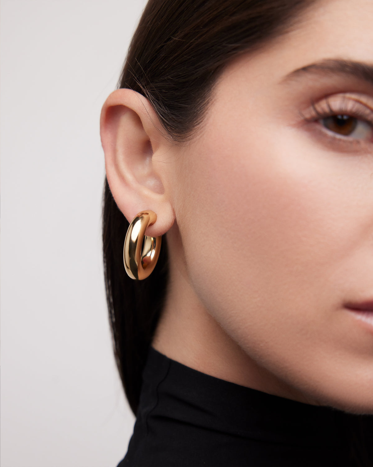 Samira Huggies earring - alternate angle | gold huggie earrings