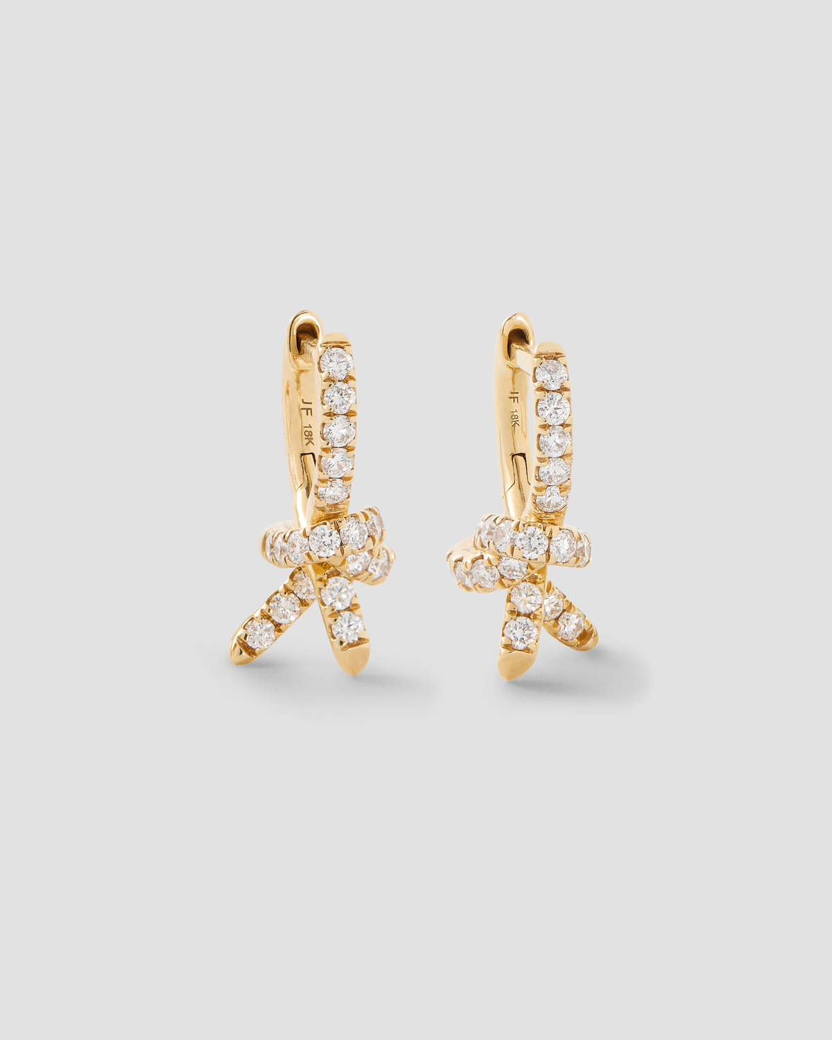 Knot Micro Huggie with Pavé White Diamonds gold earring - front view | diamond huggie earrings