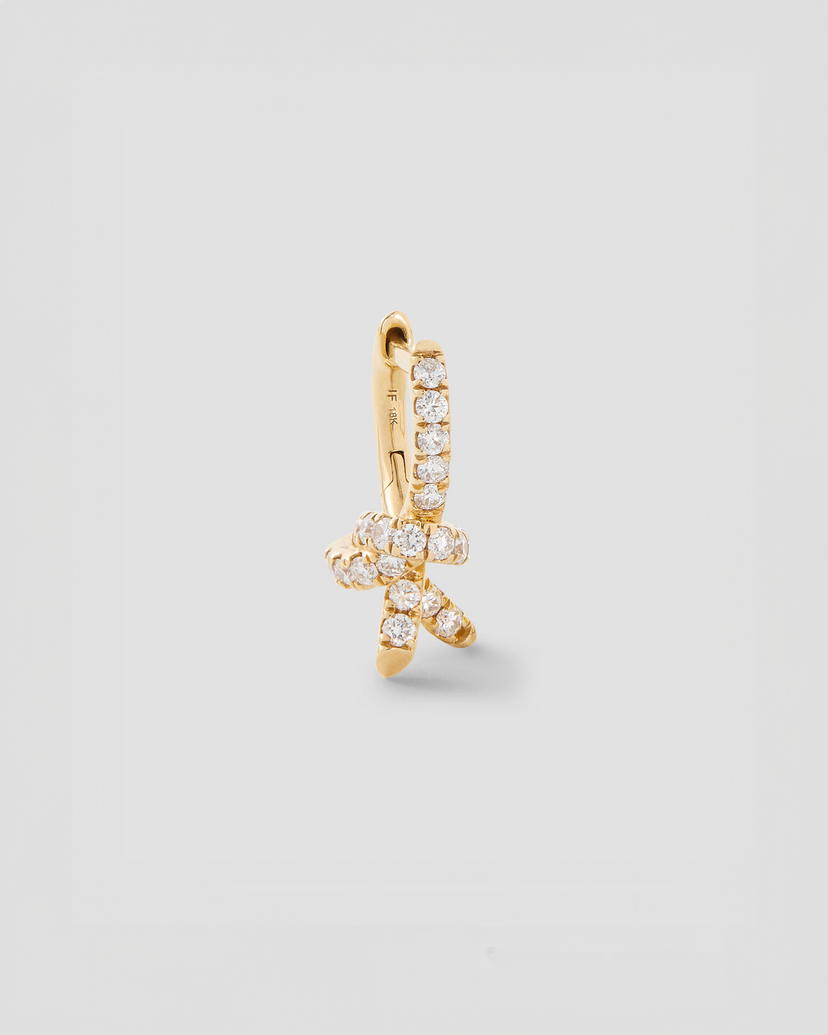 Knot Micro Huggie with Pavé White Diamonds gold earring - product detail shot | diamond huggie earrings