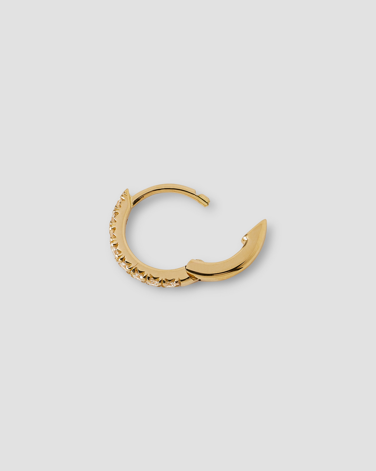 18K Essential Pavé Tiny Huggie gold earring - close-up detail | diamond huggie earrings