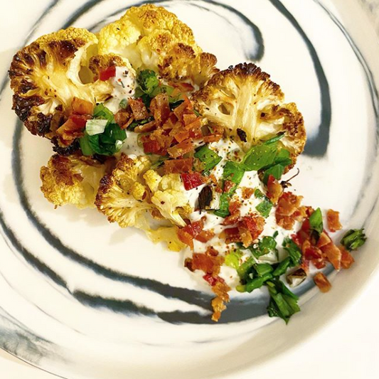 CREAMY CHILI ROASTED CAULIFLOWER WITH CHARRED SCALLION AND BACON