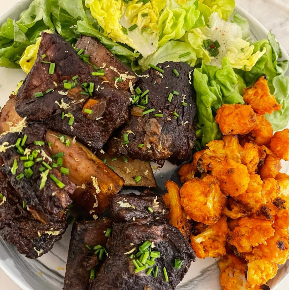 SLOW BRAISED GARLIC AND RED WINE BEEF SHORT RIBS WITH BAKED GLUTEN FREE "BUFFALO CAULIFLOWER"