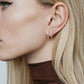 Diamond Huggie Hoops on model's ear