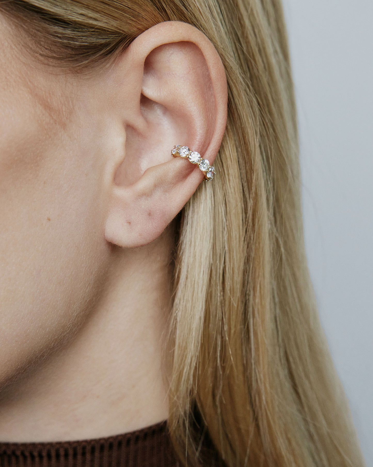 Image of diamond ear cuff on model's ear.