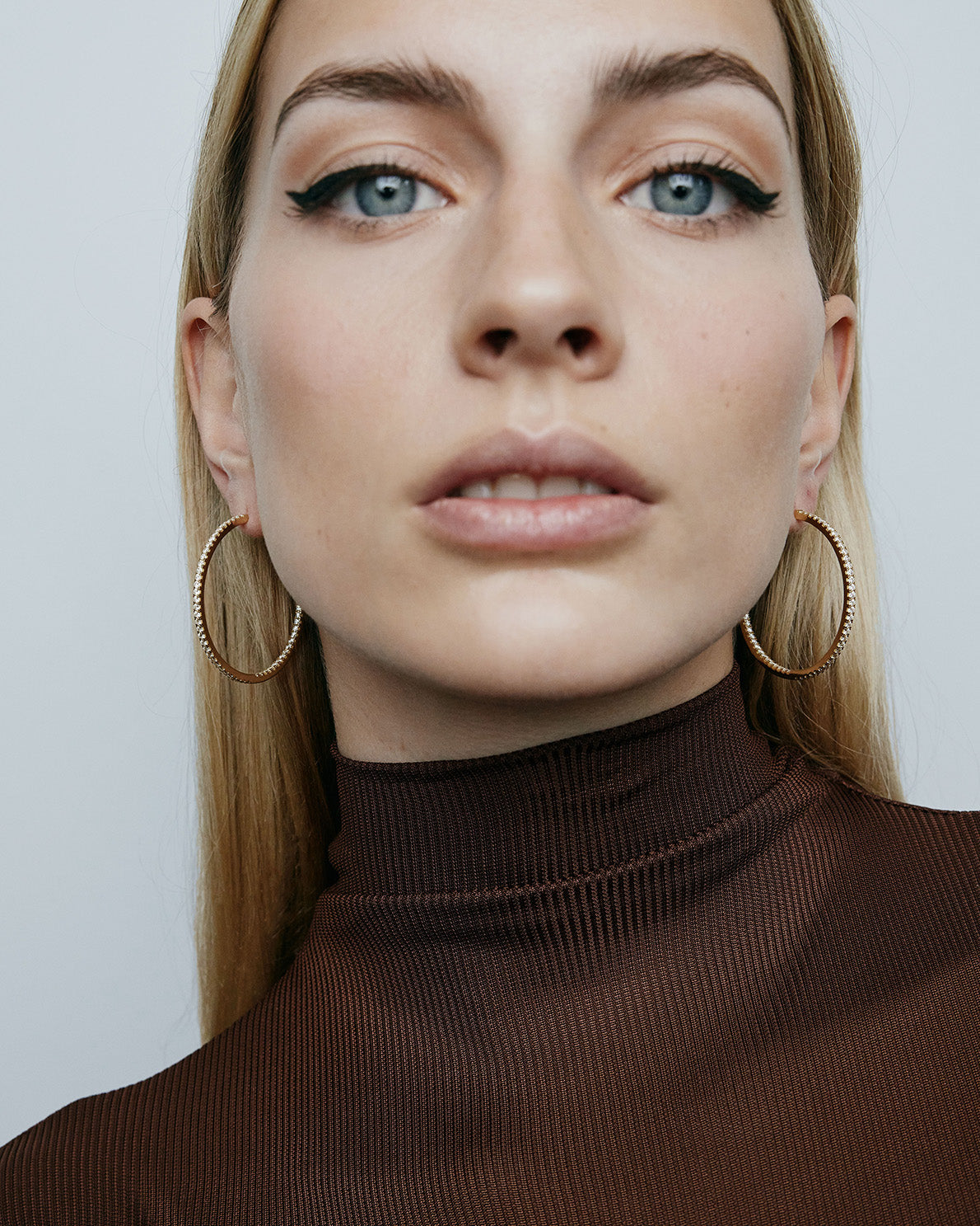 1.5" diamond hoops on model wearing brown top