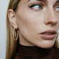 1" diamond hoops on model wearing brown top