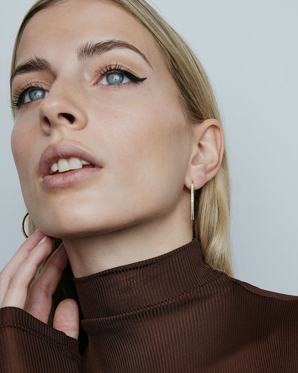 1" diamond hoops on model wearing brown top