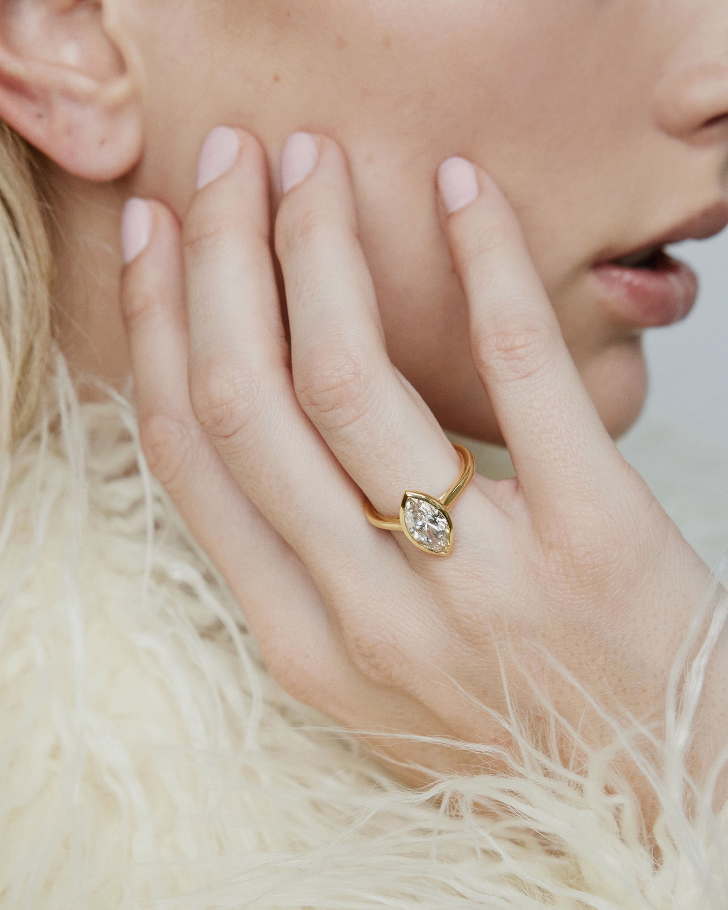 Model wearing Marquise shaped diamond on a gold band