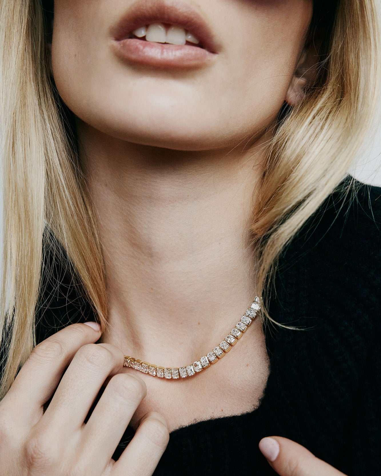 Close up of model wearing a diamond necklace