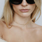 Image of model wearing sunglasses and diamond tennis necklace