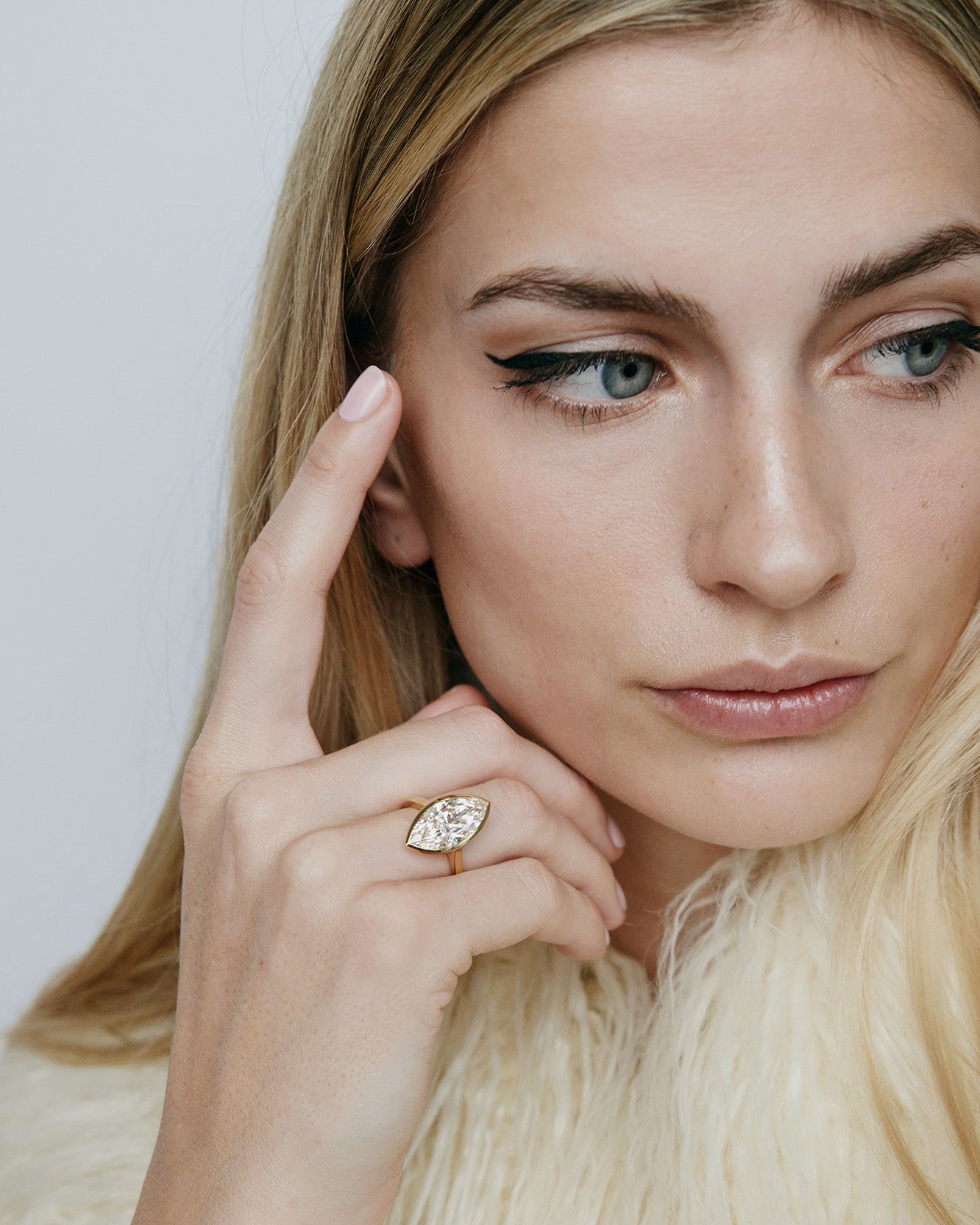 Model wearing Marquise shaped diamond on a gold band