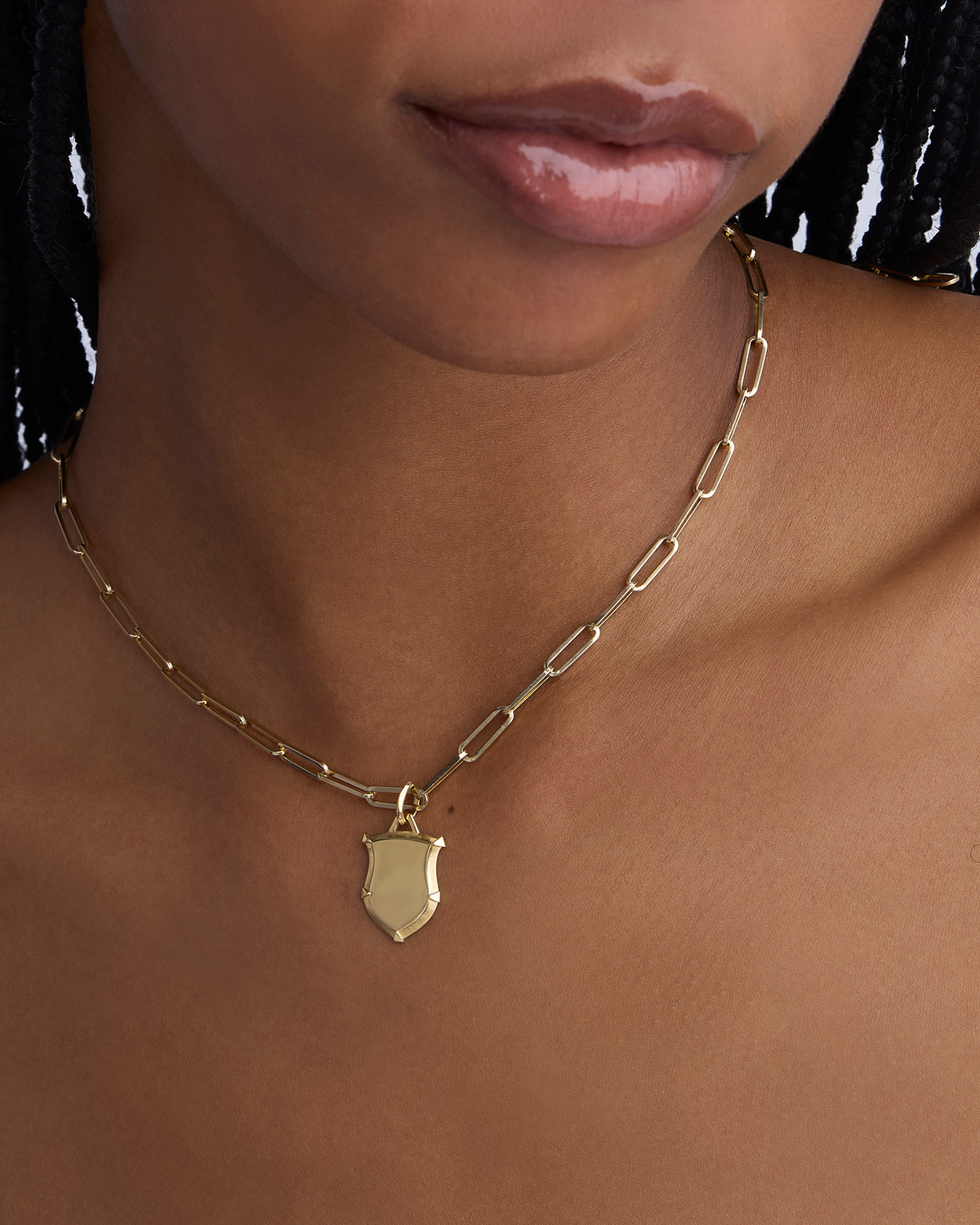 Mini Classic Shield in 18K Yellow Gold charm - close-up detail | gold charm necklace
