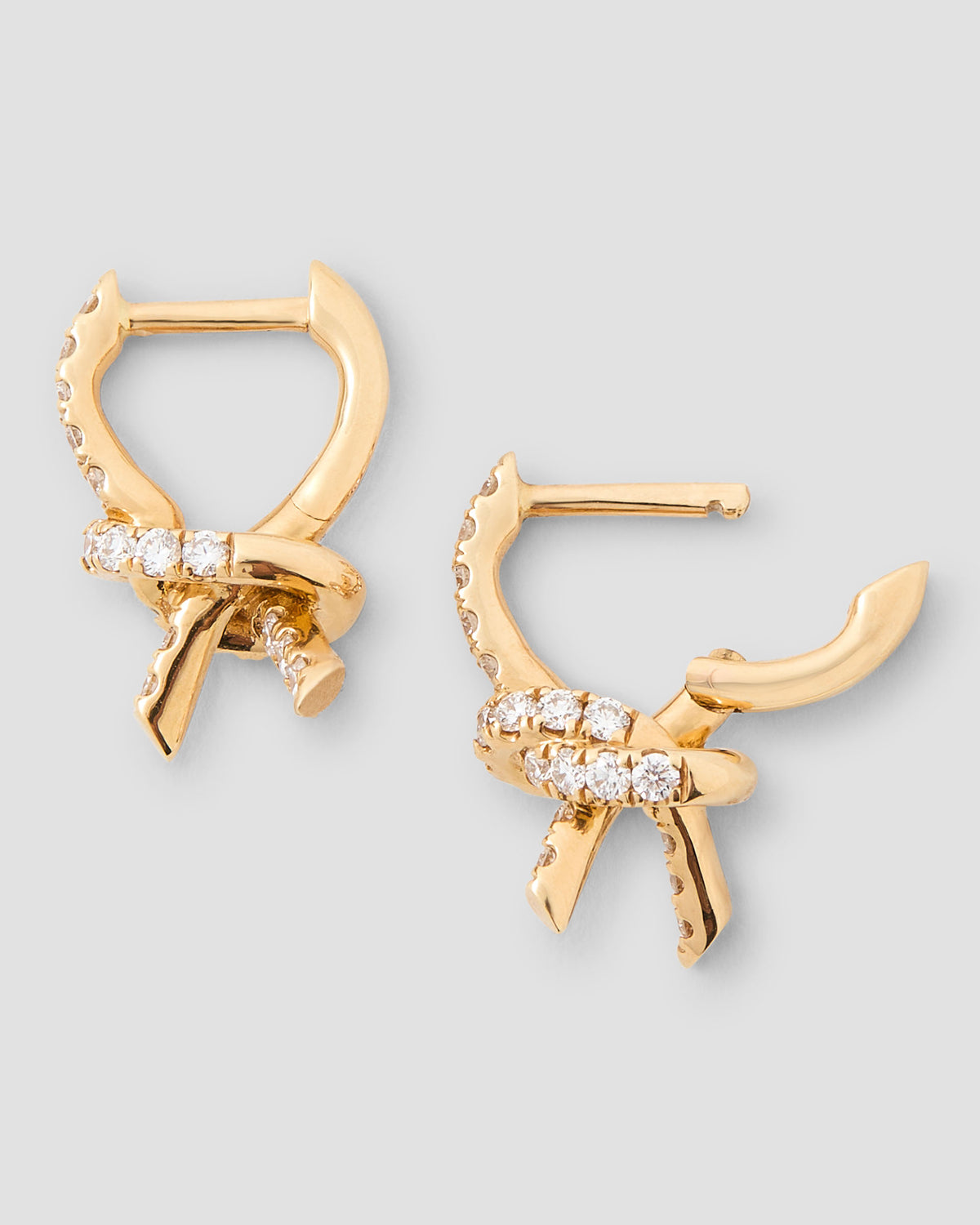 Knot Micro Huggie with Pavé White Diamonds gold earring - alternate angle | diamond huggie earrings