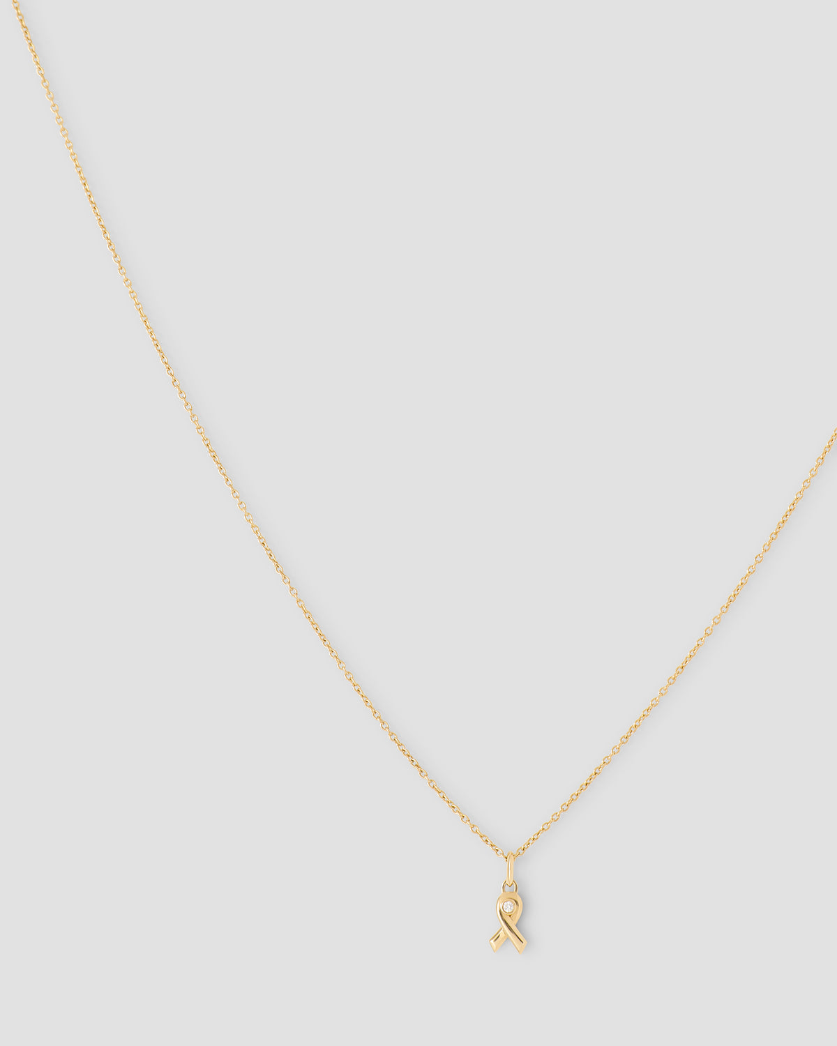 Breast Cancer Awareness Necklace charm - styled on model | gold charm necklace