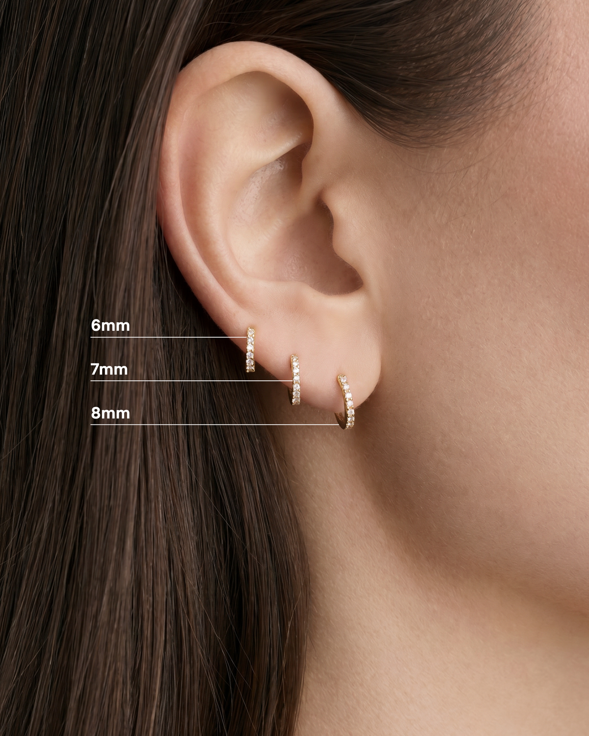 18K Essential Pavé Tiny Huggie gold earring - close-up detail | diamond huggie earrings