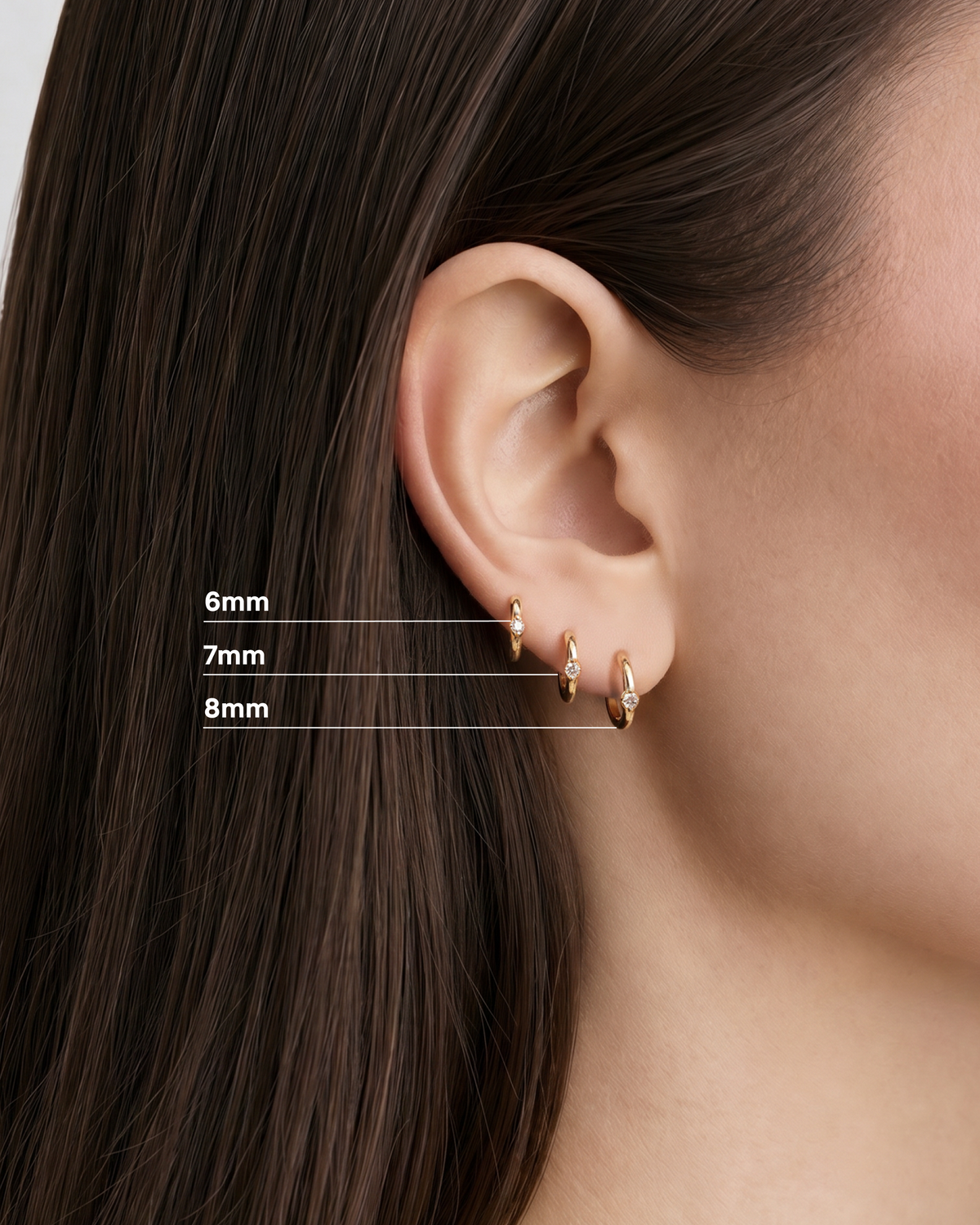 18K Essential Single Stone Tiny Huggie gold earring - close-up detail | diamond huggie earrings