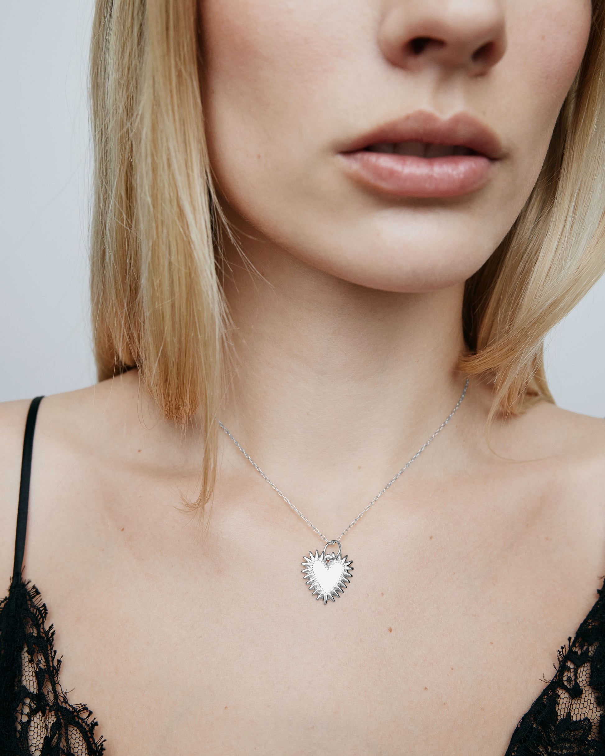 Image of model wearing the plain Fierce Heart charm on a chain