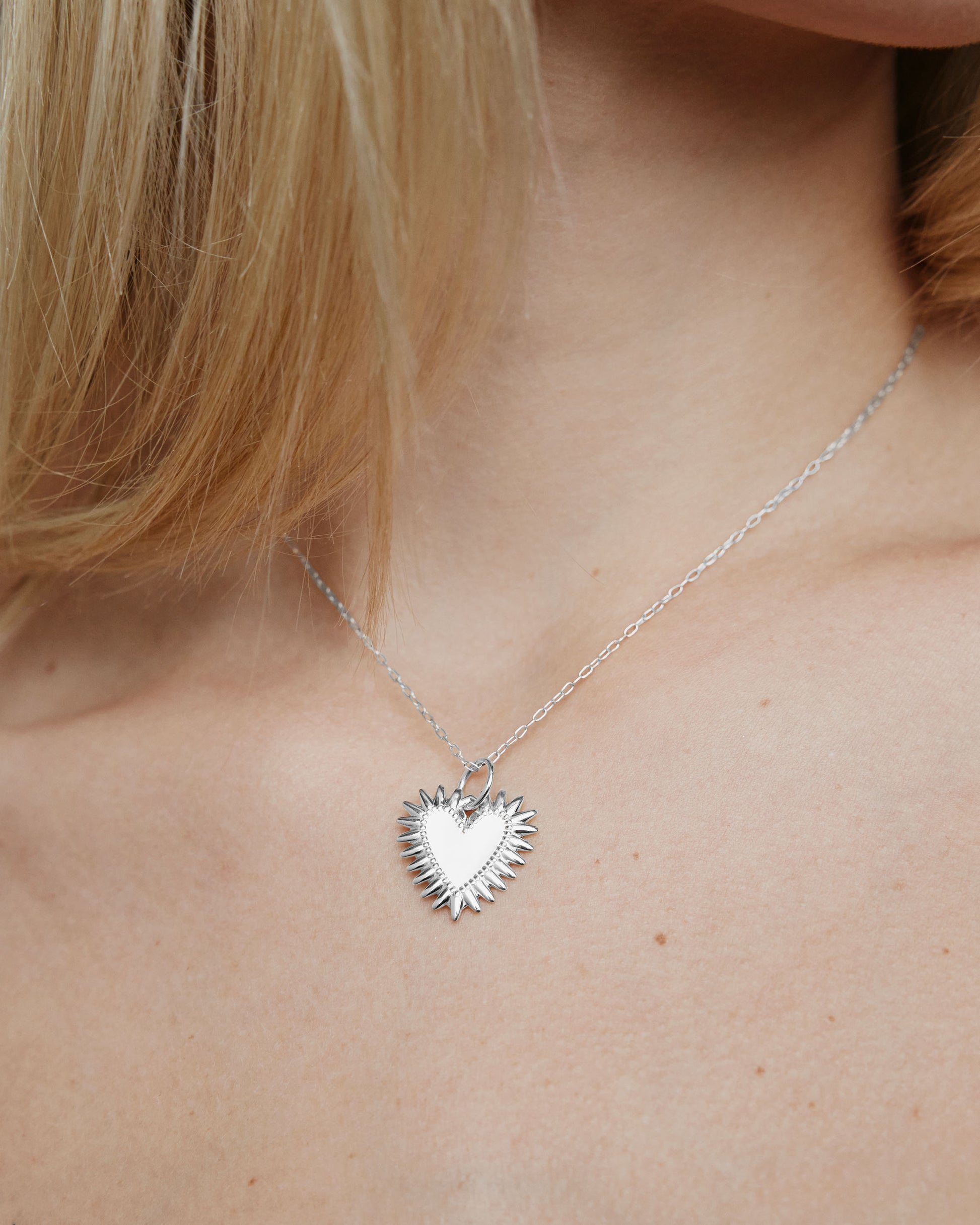 Image of model wearing the plain Fierce Heart charm on a chain