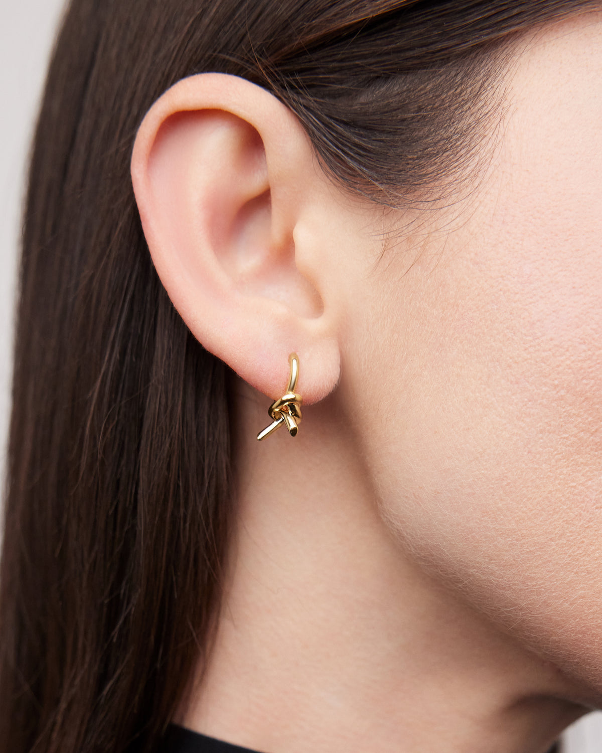 Knot Micro Huggie earring - close-up detail | gold huggie earrings