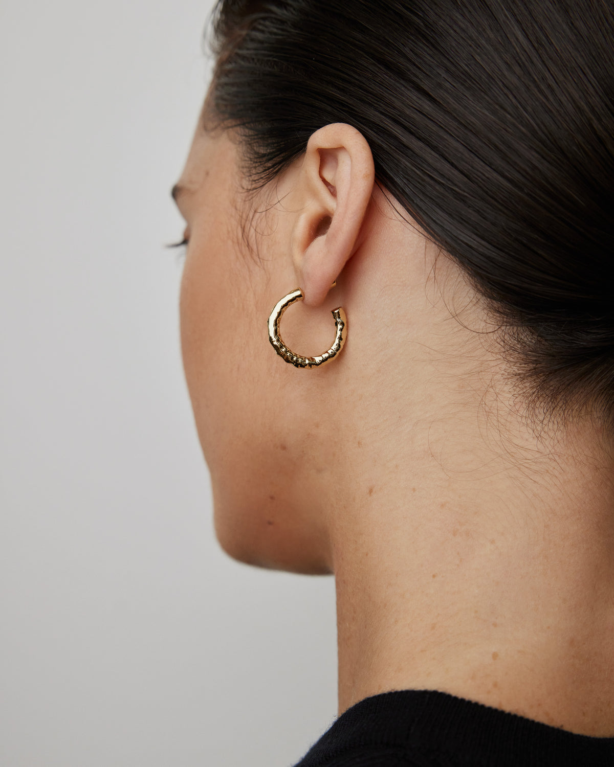 Hailey Huggies earring - alternate angle | gold huggie earrings