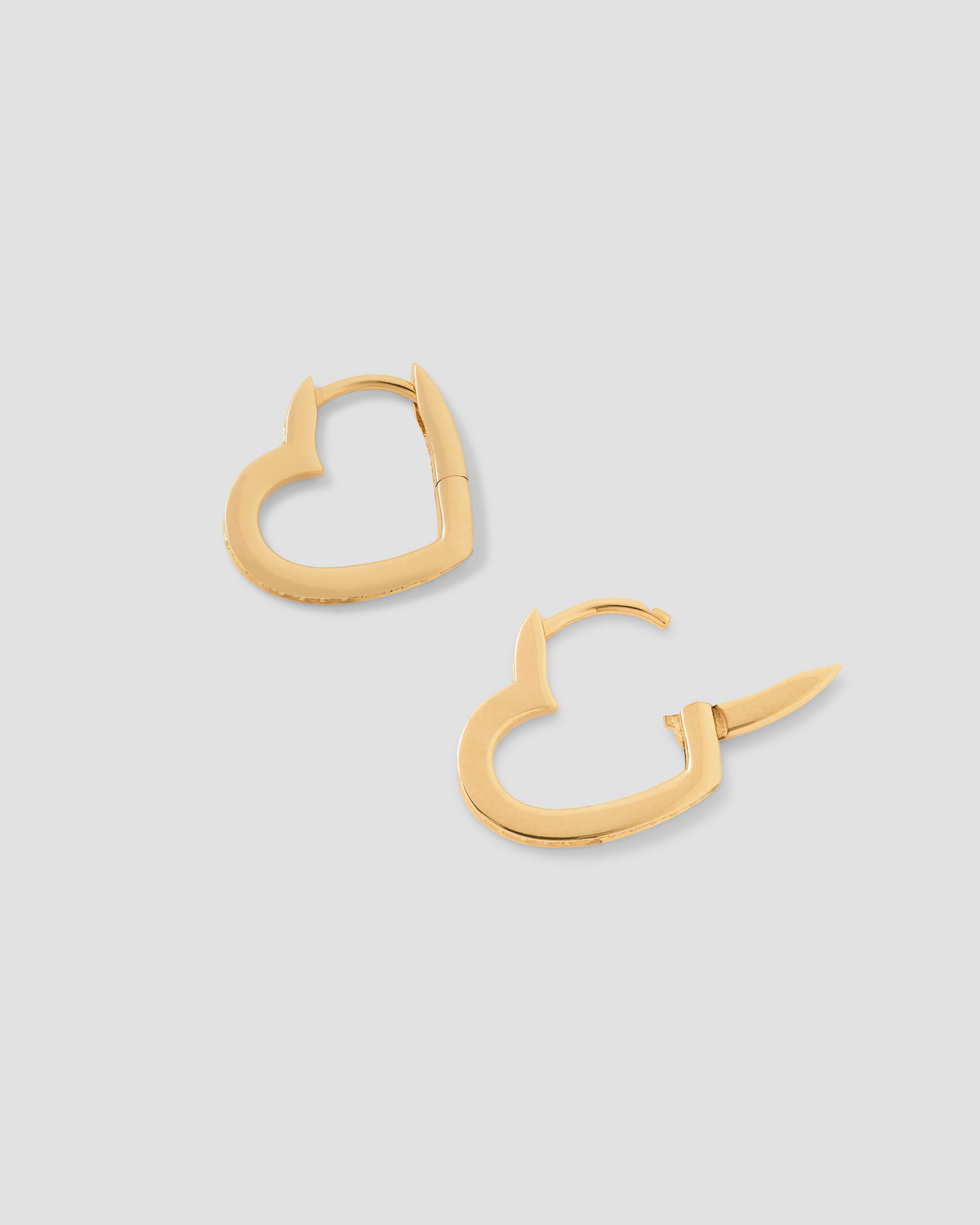 18k Small Heart Huggie With Pavé White Diamonds gold earring - styled on model | diamond huggie earrings