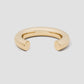 Gold bracelet on a light gray background