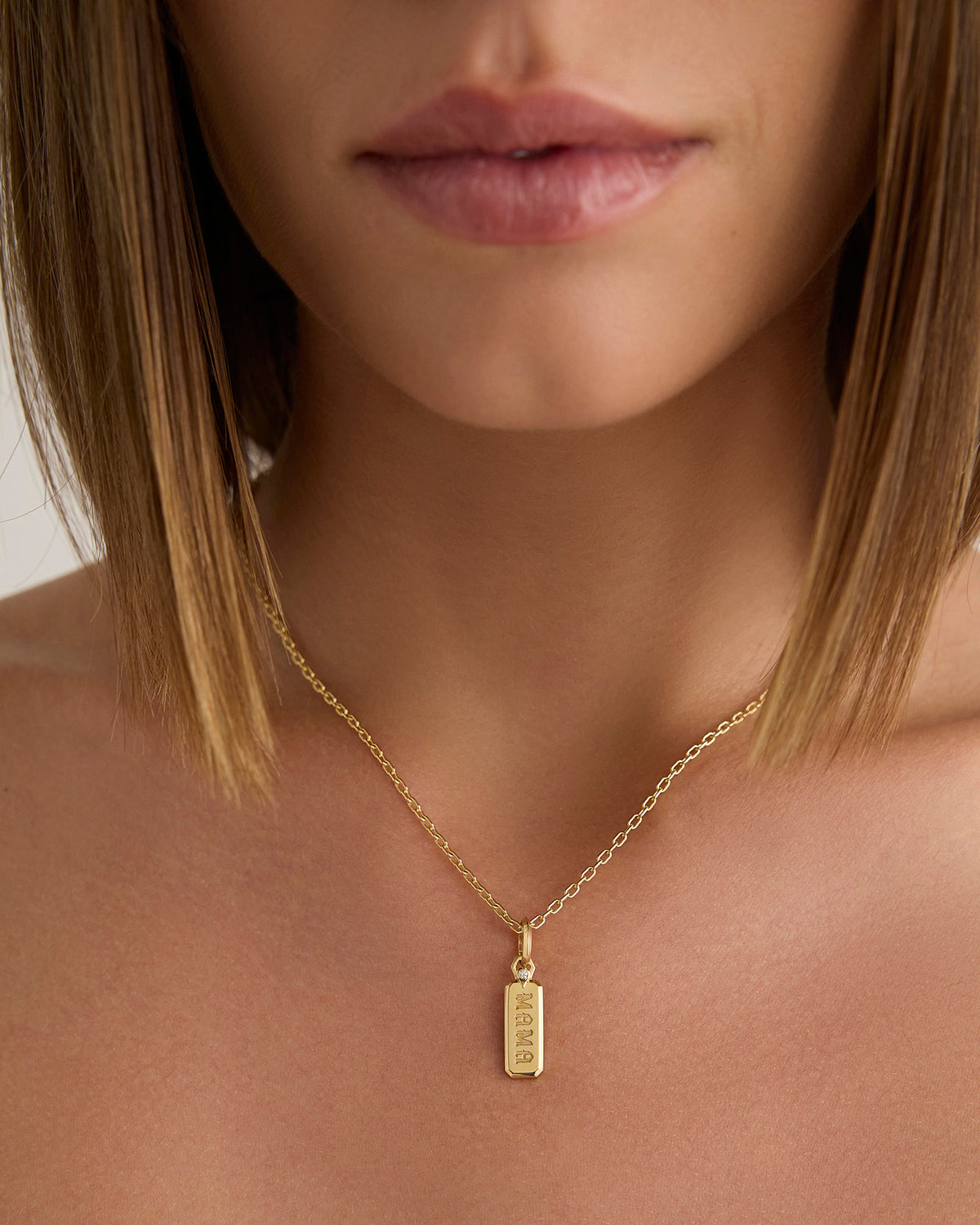 Small Mama Dog Tag in 18K Yellow gold charm - close-up detail | charm necklaces