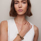 Model posing wearing bracelet. 