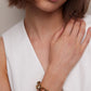 Model posing wearing bracelet. 