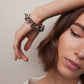 Model posing wearing bracelet. 
