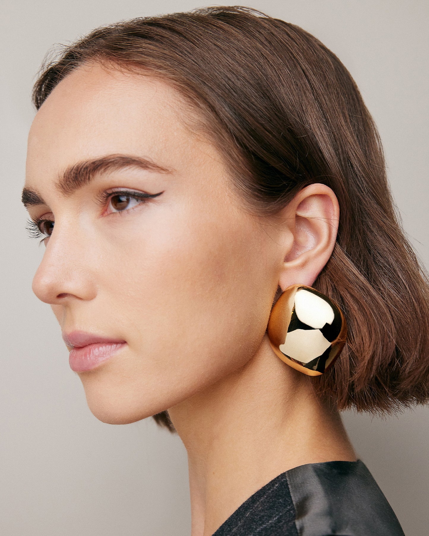 Model wearing Puffy Cushion Earrings. 