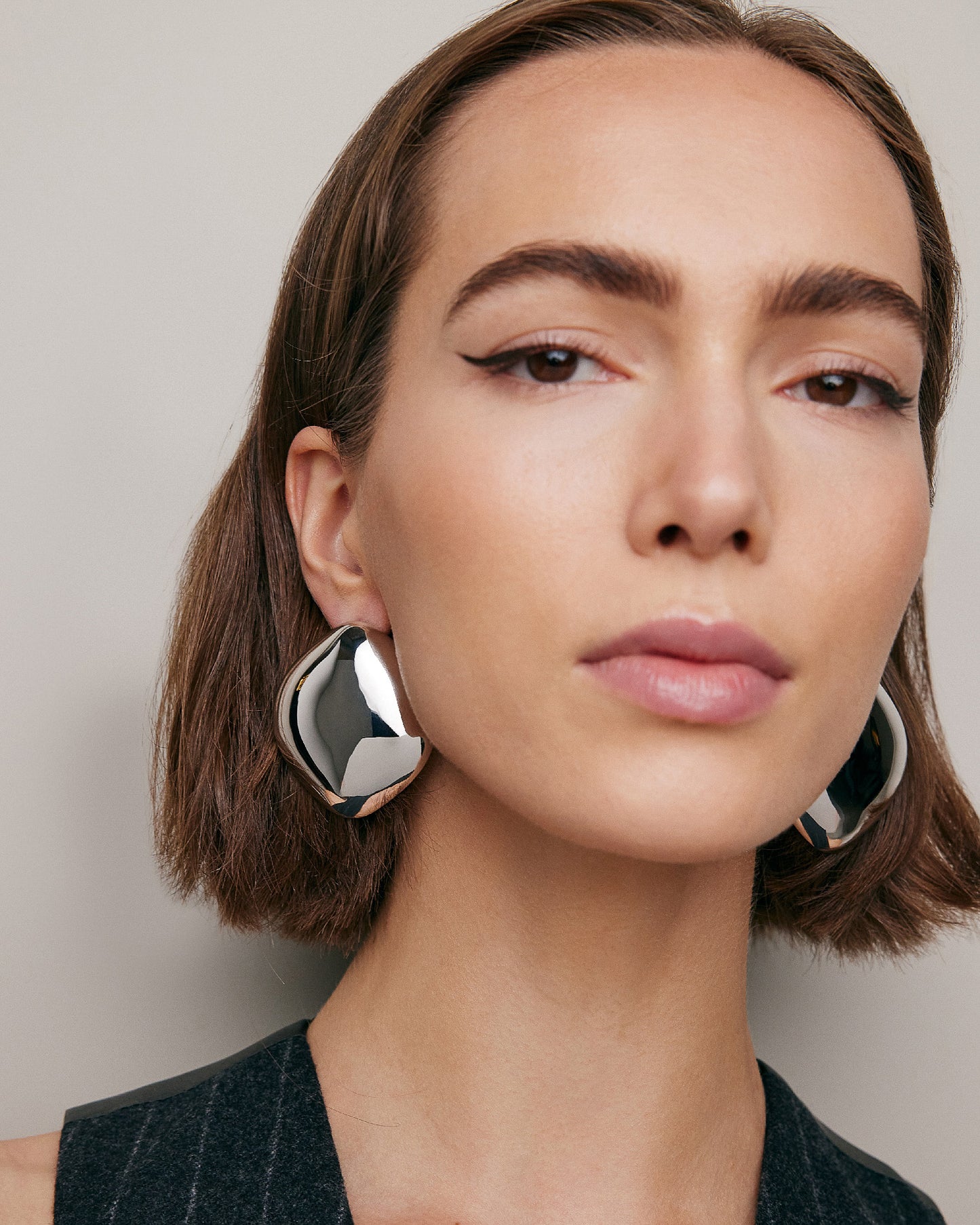 Model wearing Puffy Cushion Earrings. 