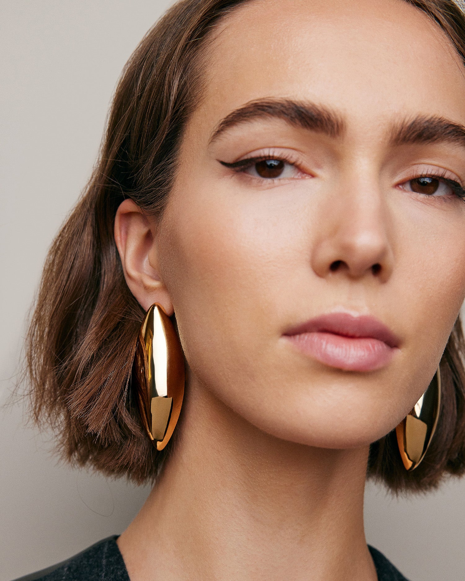 Model wearing Puffy Dagger earrings. 