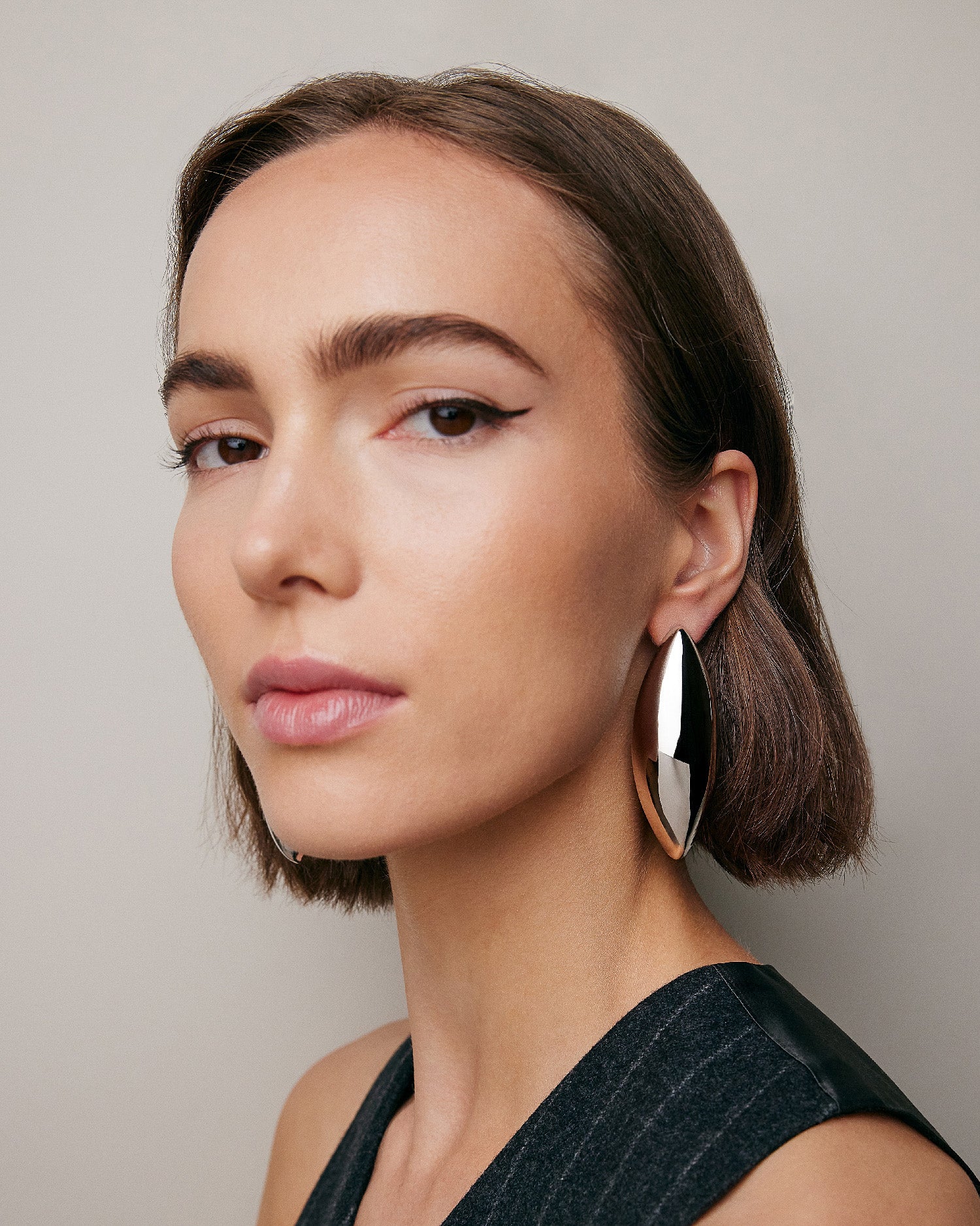 Model wearing Puffy Dagger earrings. 