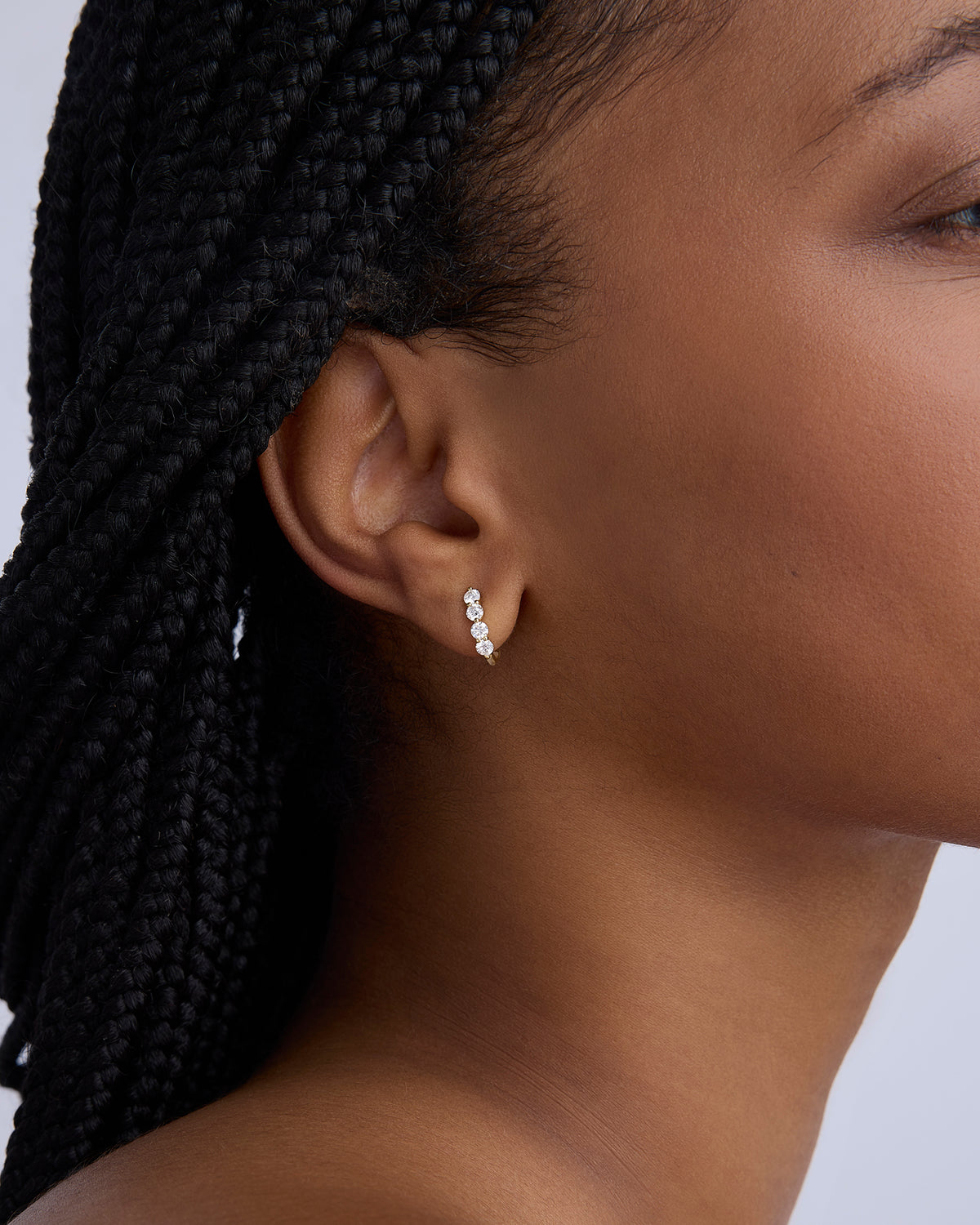 Floating Four Diamond Huggies gold earring - close-up detail | diamond huggie earrings