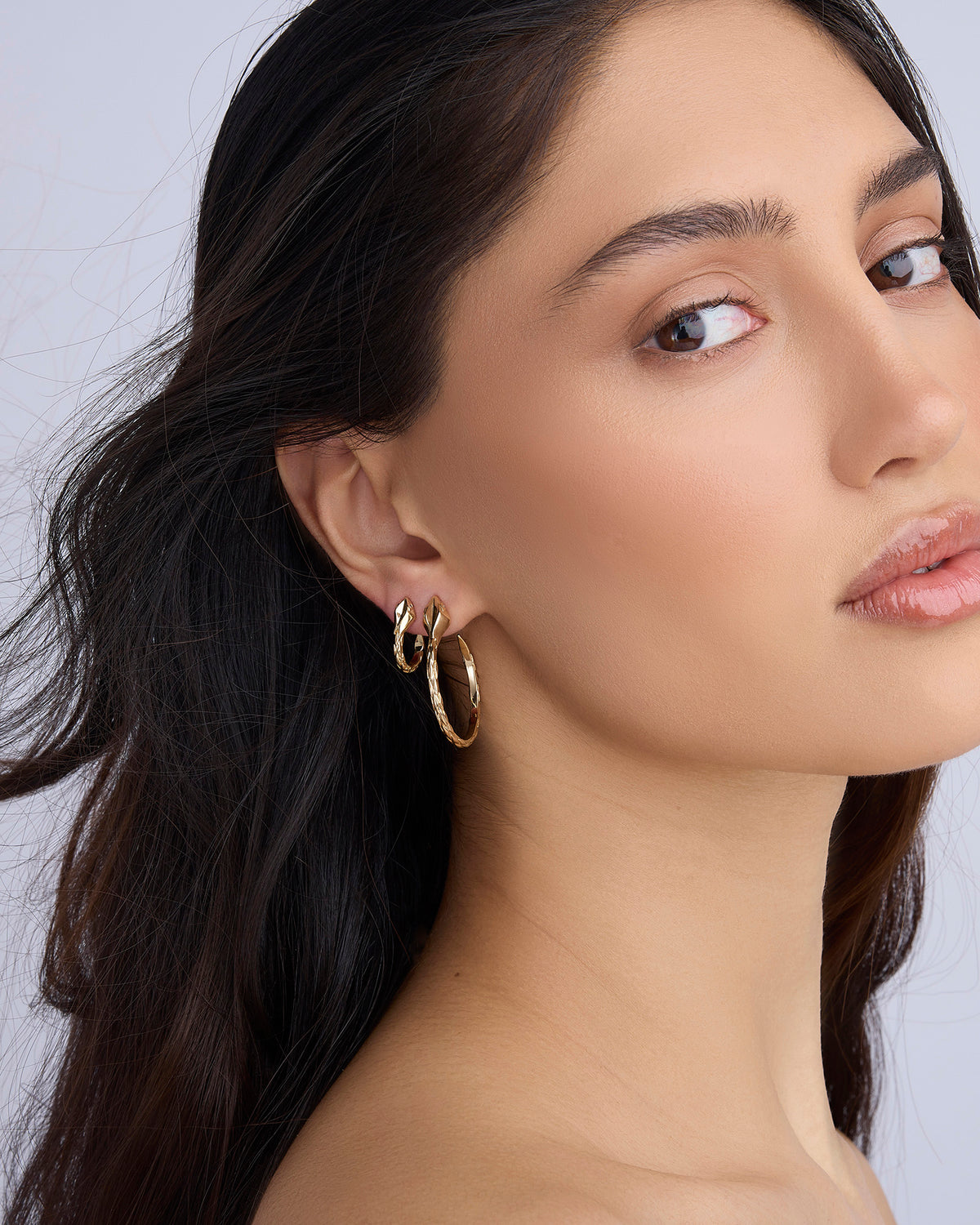 Snake Huggies earring - styled on model | gold huggie earrings