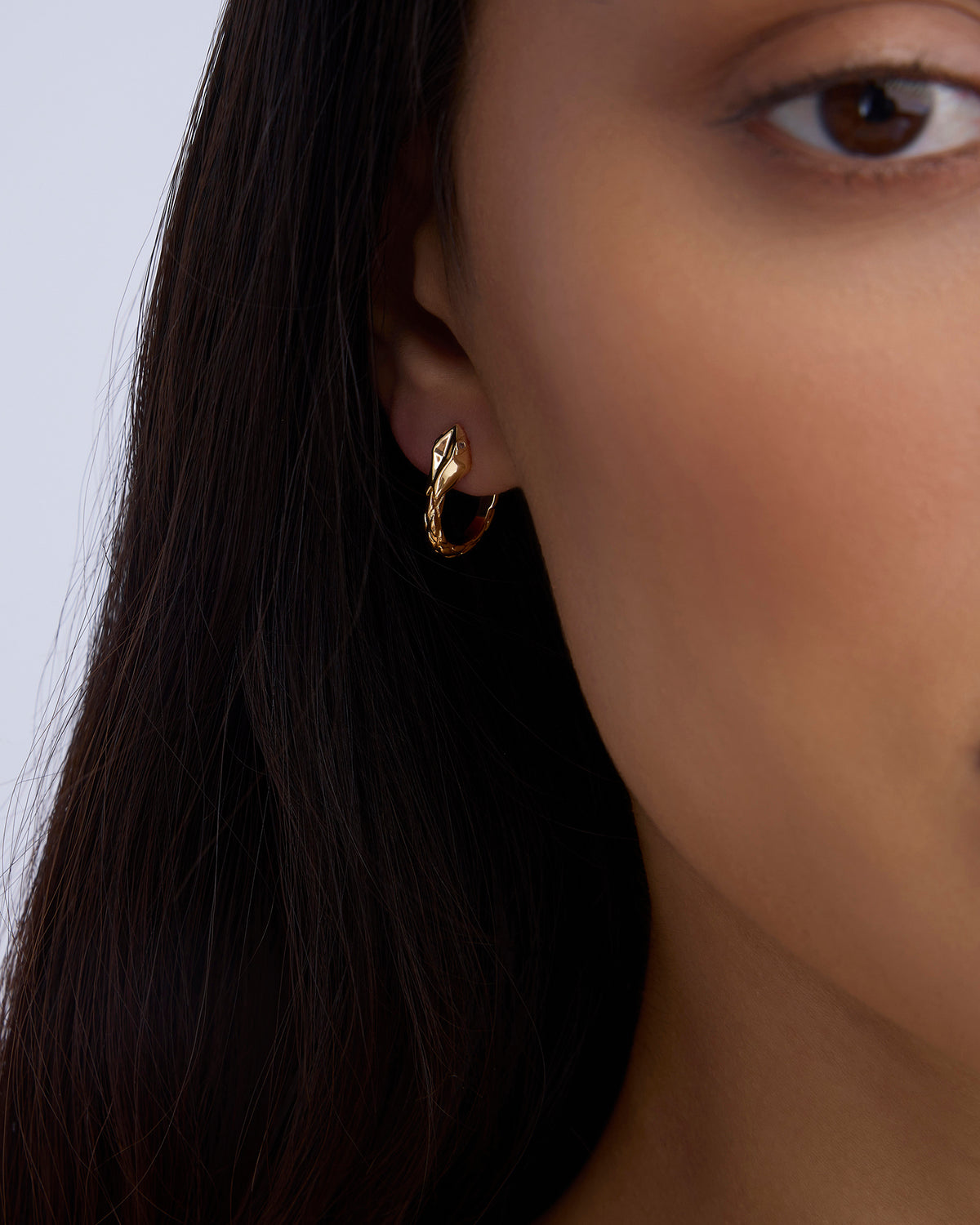 Snake Huggies earring - close-up detail | gold huggie earrings