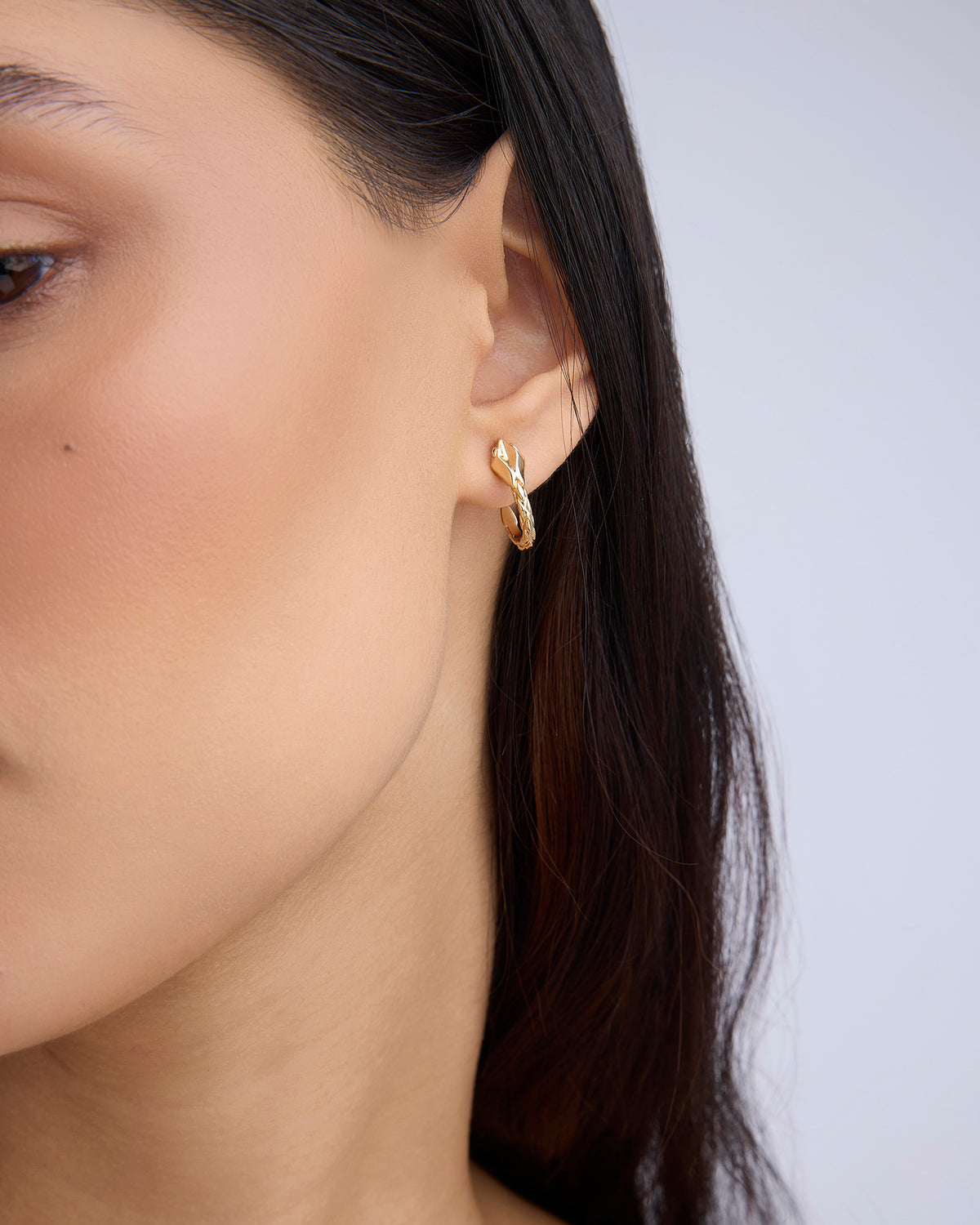 Snake Huggies earring - alternate angle | gold huggie earrings