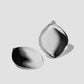 Puffy Cushion earrings on grey background.