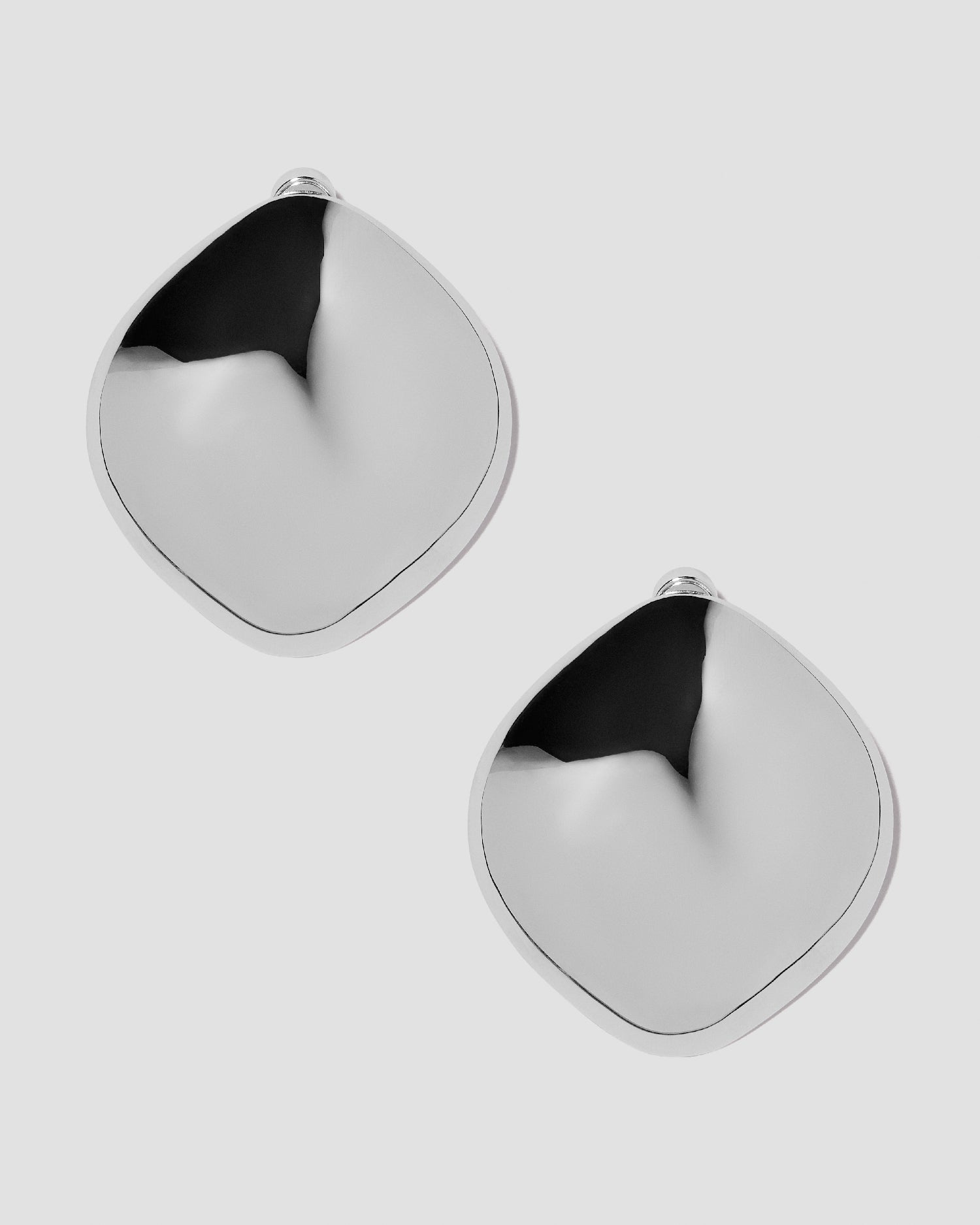 Puffy Cushion earrings on grey background.