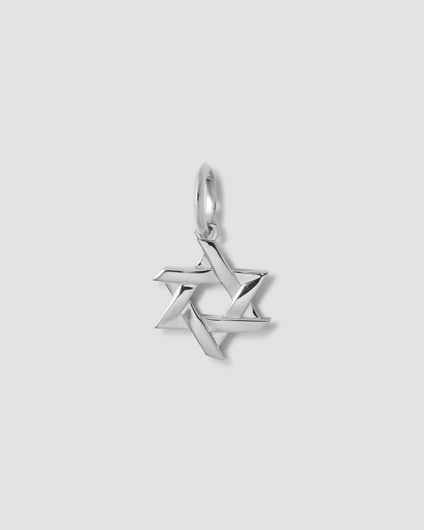 Silver Star of David pendant on a light gray background