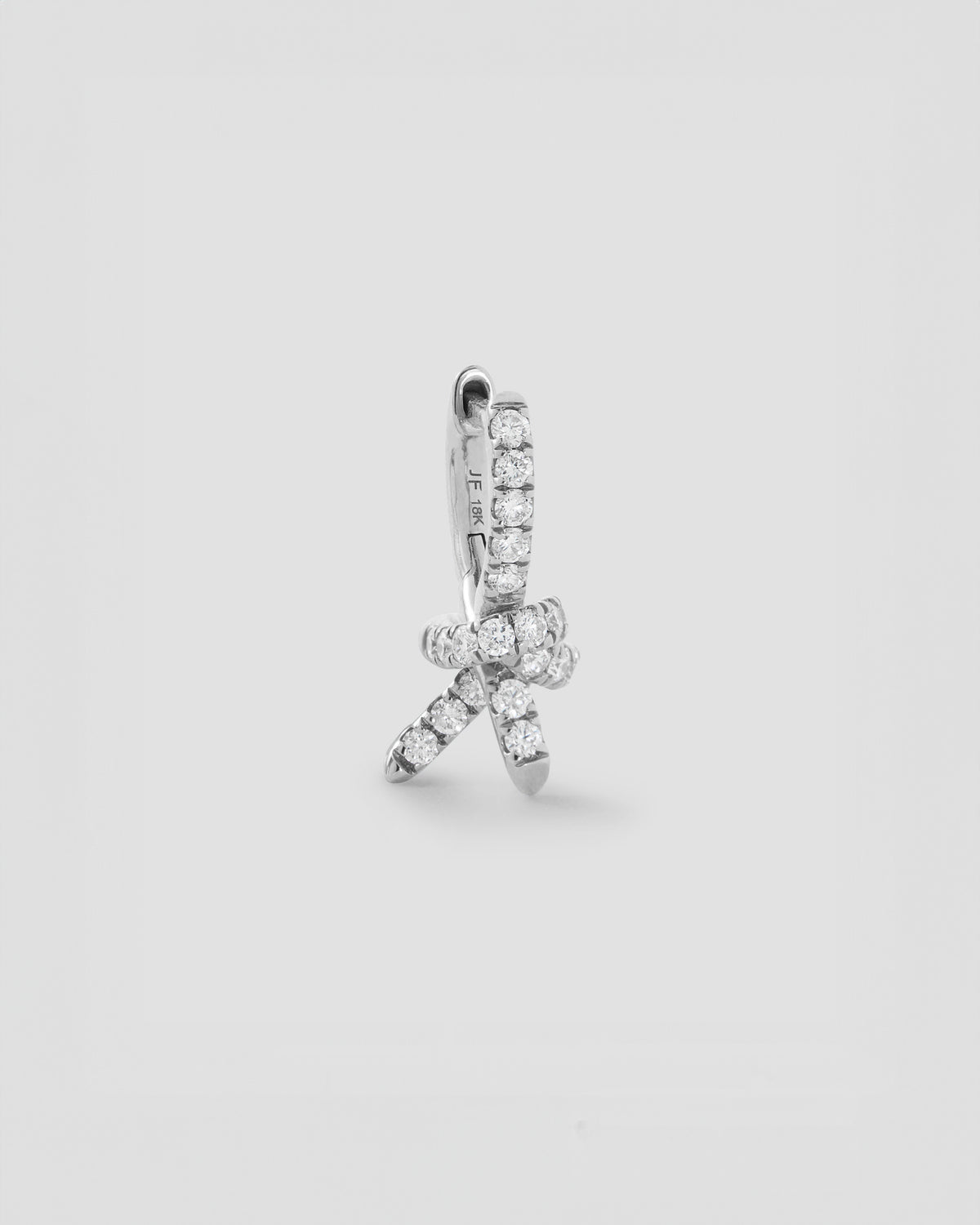 Knot Micro Huggie with Pavé White Diamonds gold earring - close-up detail | diamond huggie earrings